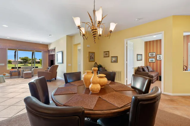 a dining room with furniture and window