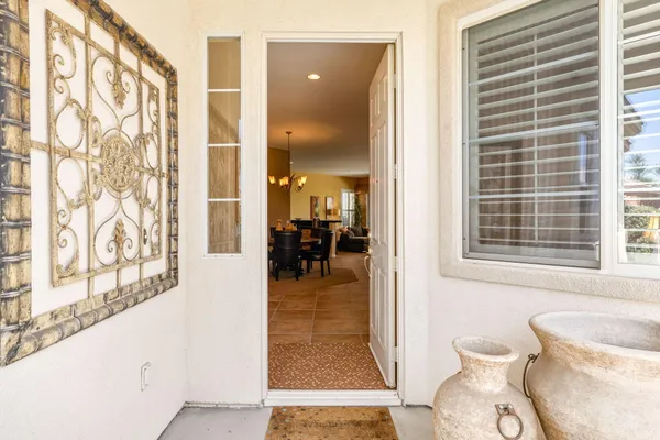 a hallway with a dining table and chairs