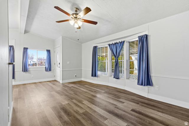 150 West 7500th South, Unit 55 Midvale, UT 84047 - Photo 9 of 28 Spare room with ceiling fan, wood finished floors, and lofted ceiling