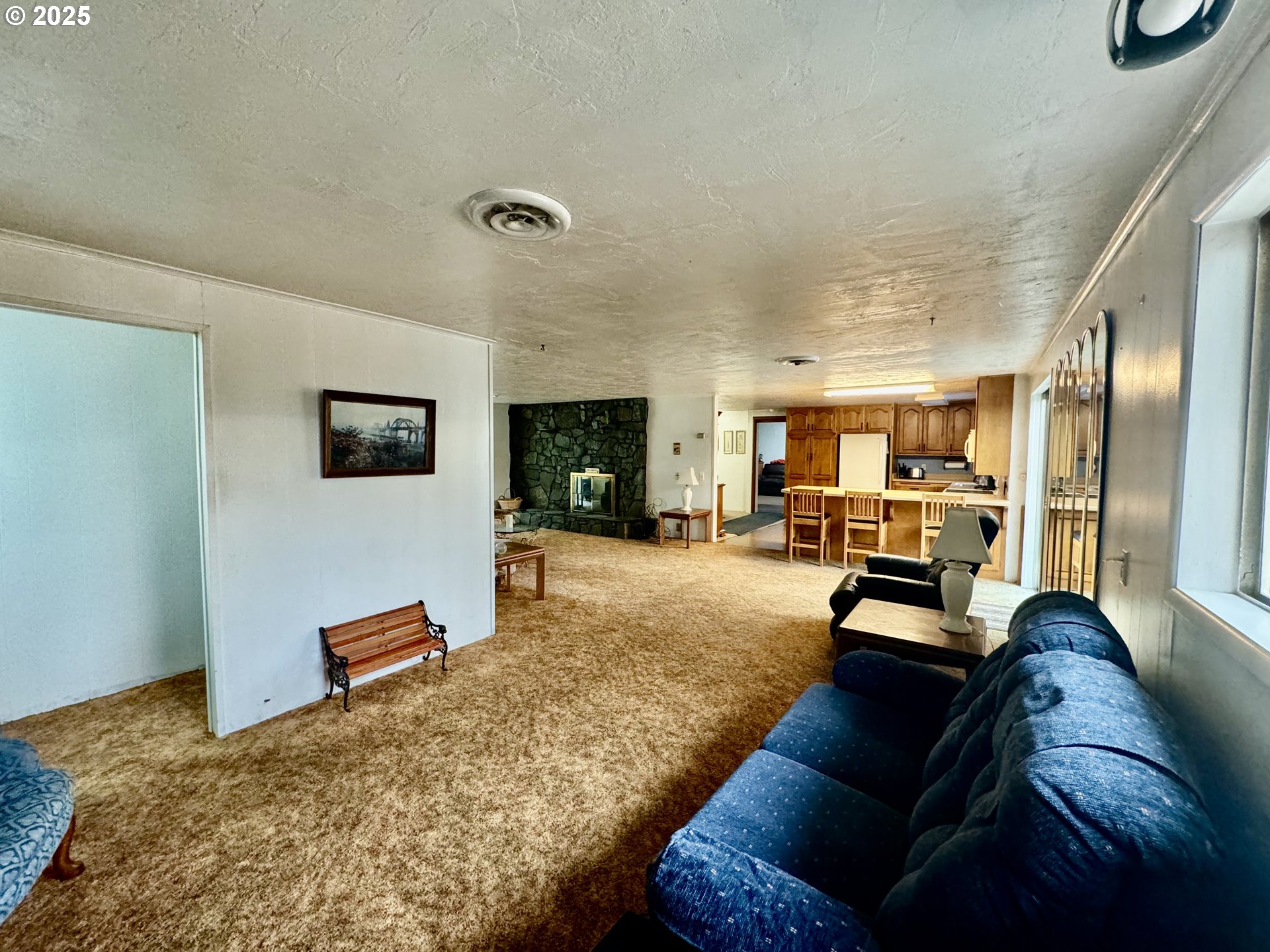 4990 Mitchell Loop Road Florence, OR 97439 - Photo 20 of 37 a living room with furniture and a flat screen tv