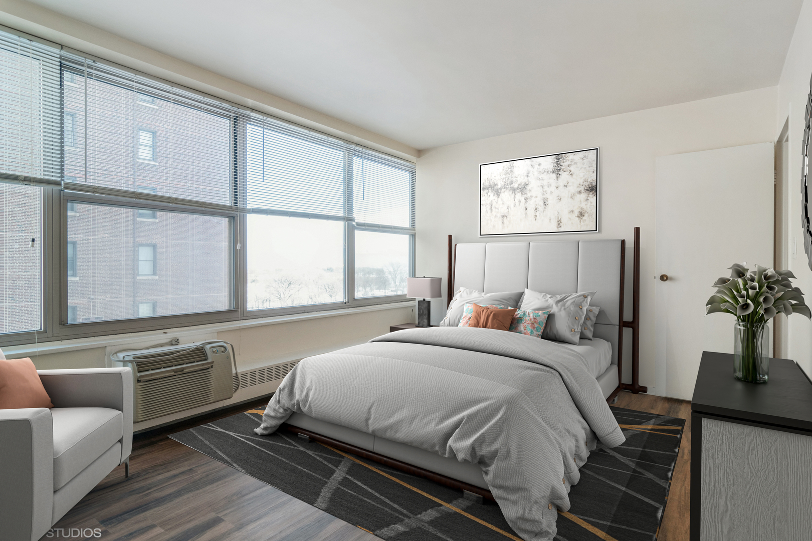 3900 North Lake Shore Drive, Unit 9J Chicago, IL 60613 - Photo 11 of 18 a bedroom with a bed and a couch