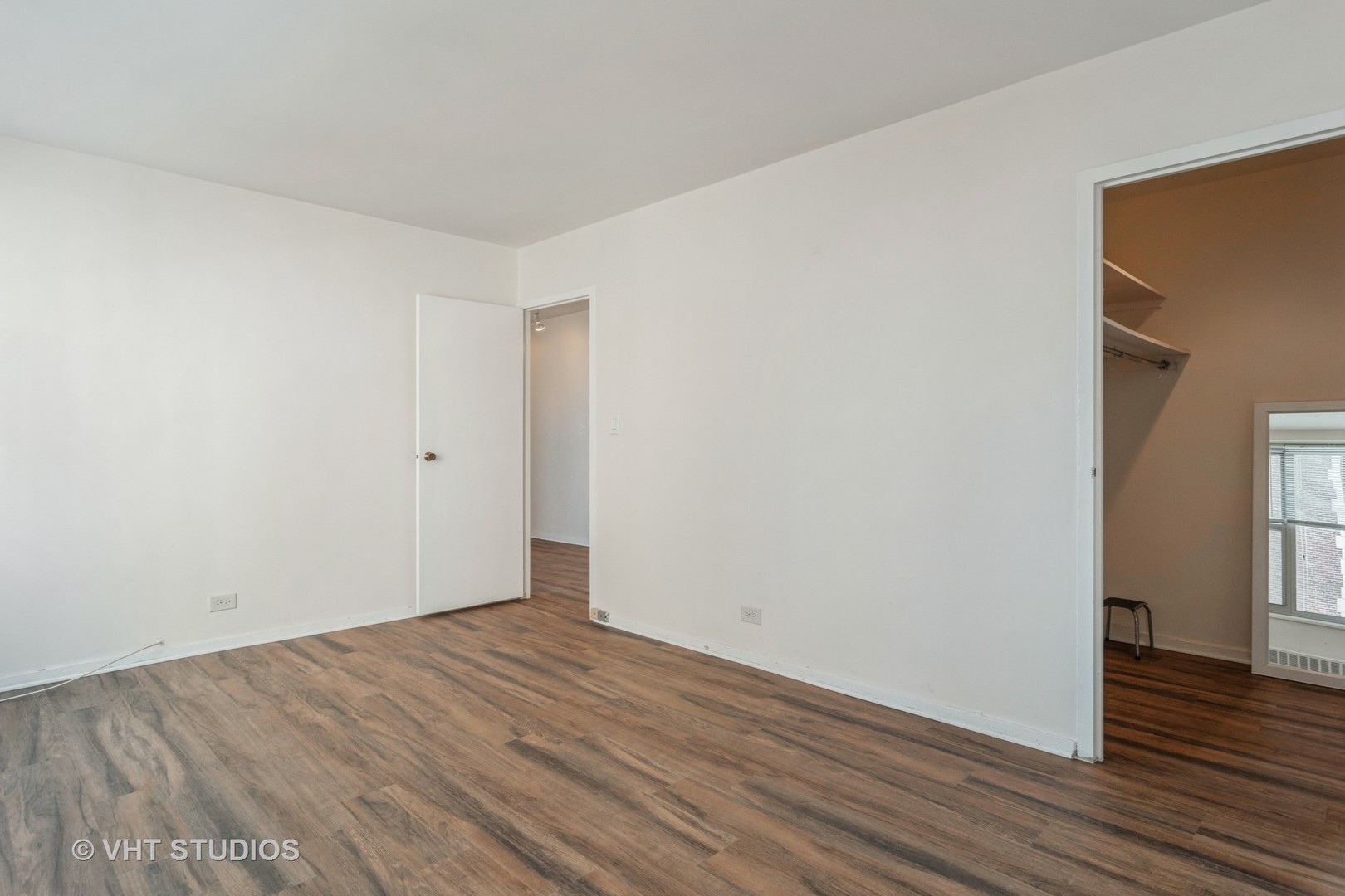 3900 North Lake Shore Drive, Unit 9J Chicago, IL 60613 - Photo 12 of 18 an empty room with wooden floor