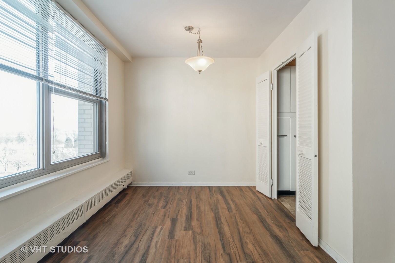 3900 North Lake Shore Drive, Unit 9J Chicago, IL 60613 - Photo 8 of 18 an empty room with wooden floor and windows