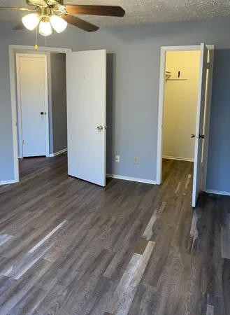 an empty room with wooden floor a chandelier