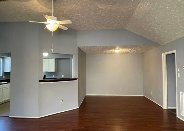 a view of a kitchen with a stove wooden floor and a ceiling fan