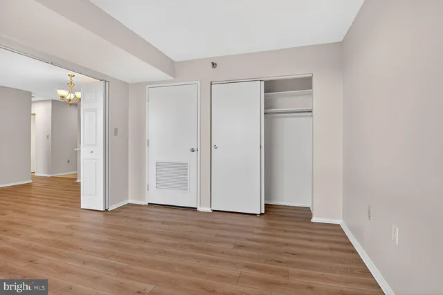 a view of an empty room with wooden floor