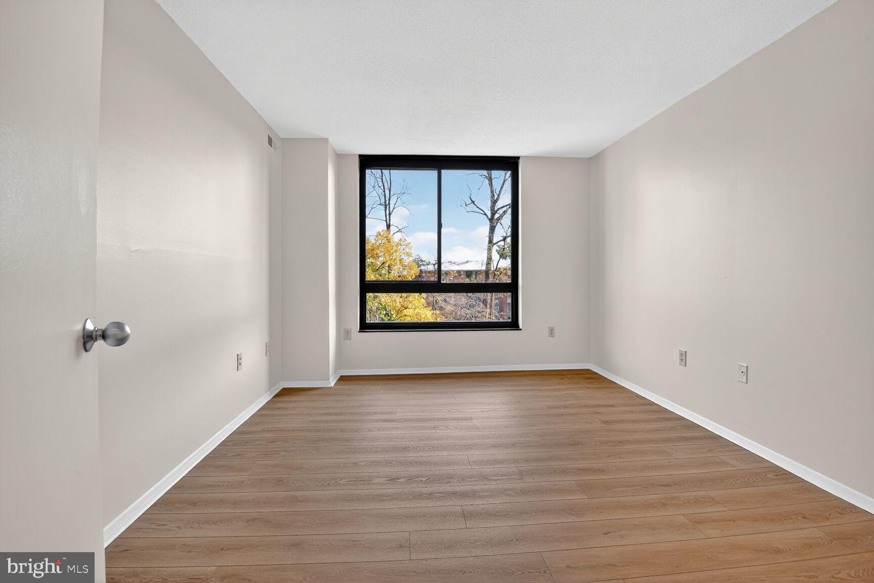 1808 Old Meadow Road, Unit 507 McLean, VA 22102 - Photo 13 of 24 wooden floor in an empty room with a window