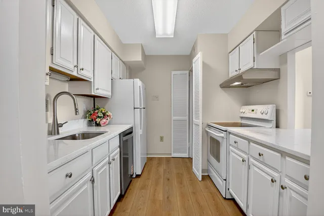 a kitchen with stainless steel appliances a sink stove and refrigerator