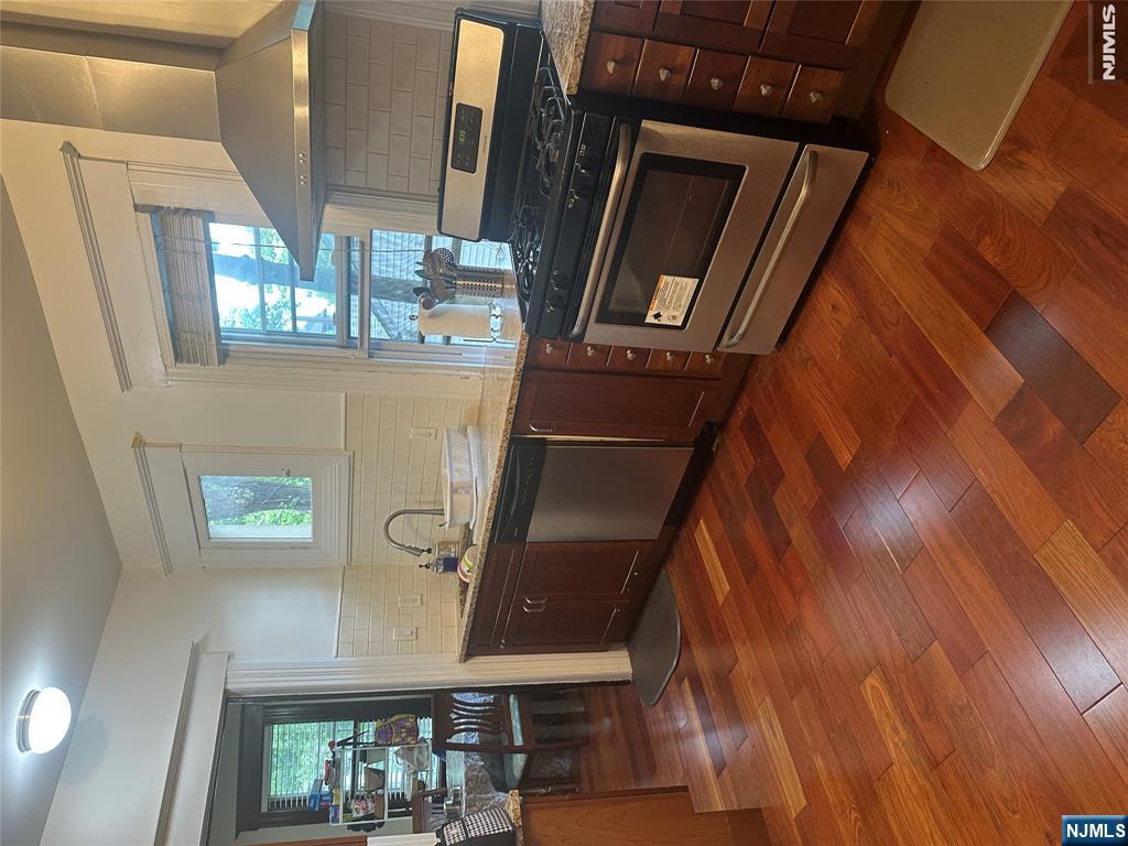 23 Highland Cross, Unit 1 Rutherford, NJ 07070 - Photo 6 of 11 a kitchen with stainless steel appliances granite countertop a stove a sink and a microwave