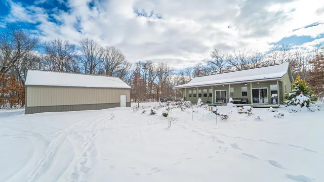 a view of patio with table and chairs under an umbrella