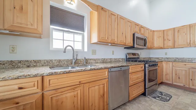 a kitchen with sink cabinets and window
