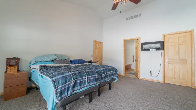 a spacious bedroom with a bed and a cabinets