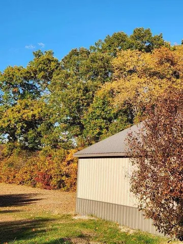 a view of a yard with a tree
