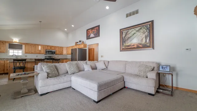 a living room with furniture and kitchen view