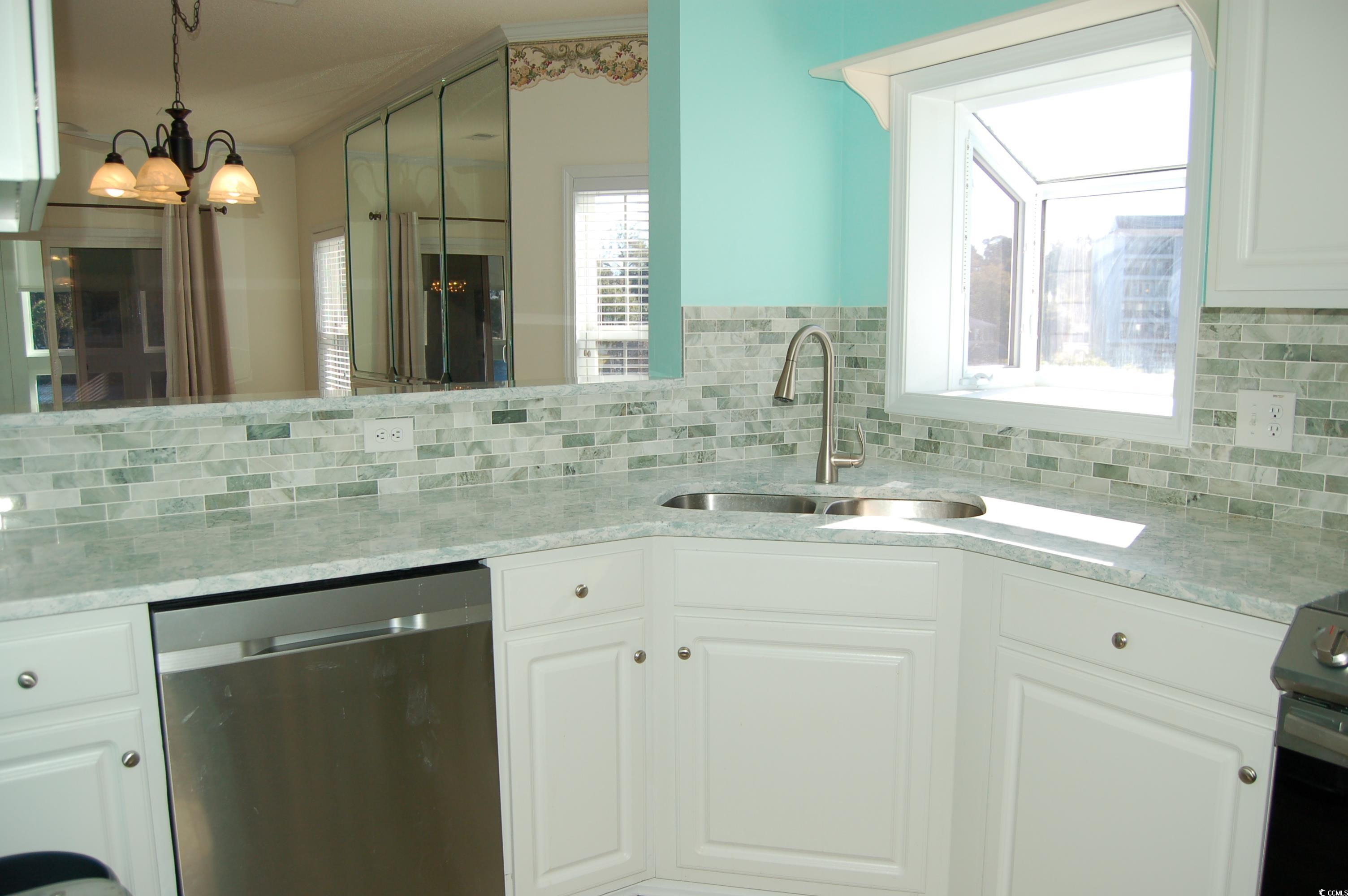 1537 Lanterns Rest Road, Unit 203 Myrtle Beach, SC 29579 - Photo 15 of 35 Kitchen featuring dishwasher, light quartz countertops, decorative light fixtures, electric stove, and tasteful backsplash