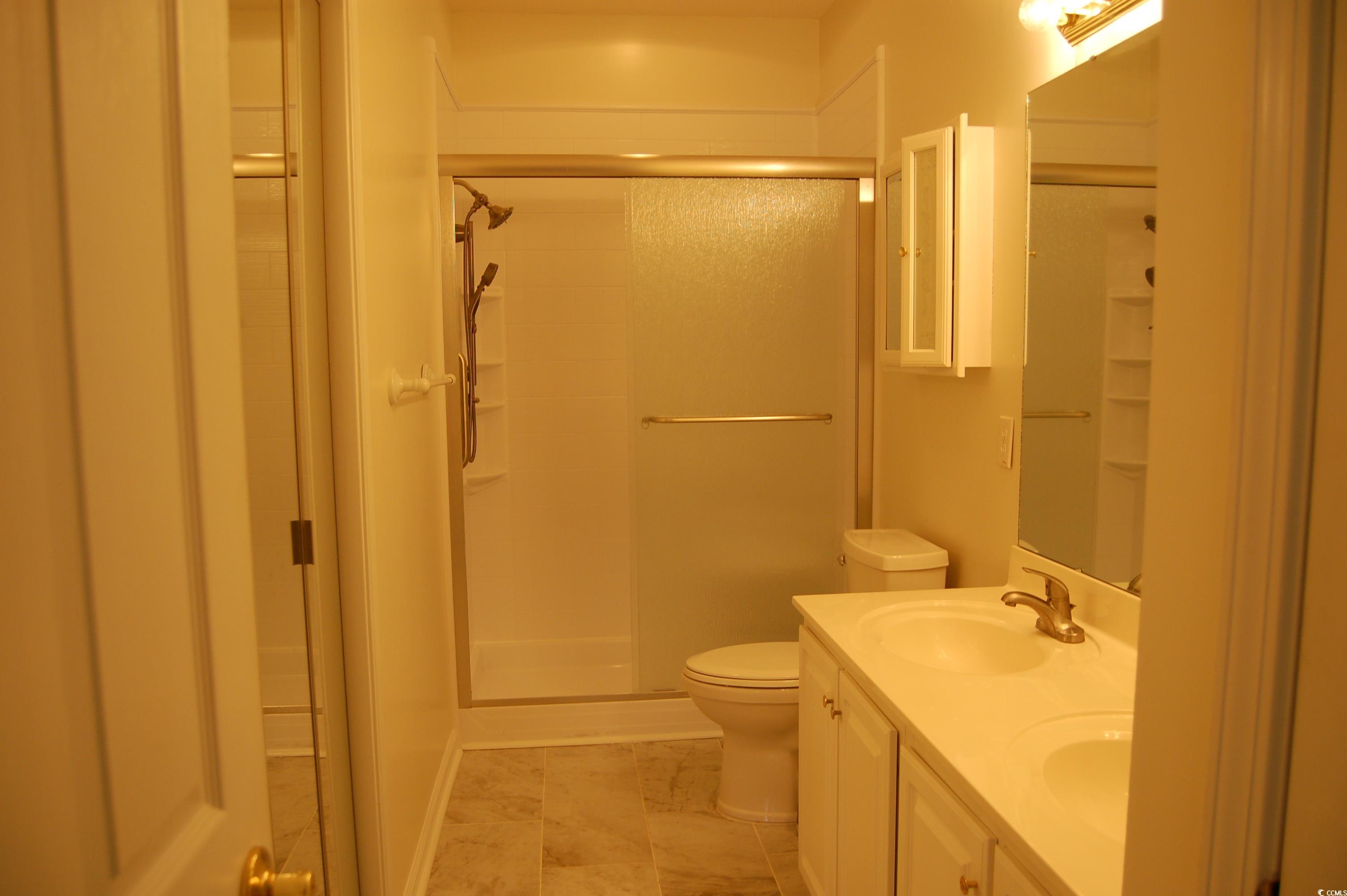 1537 Lanterns Rest Road, Unit 203 Myrtle Beach, SC 29579 - Photo 22 of 35 Bathroom with double vanity, a shower, walkin closet, linen closet and light tile patterned floors