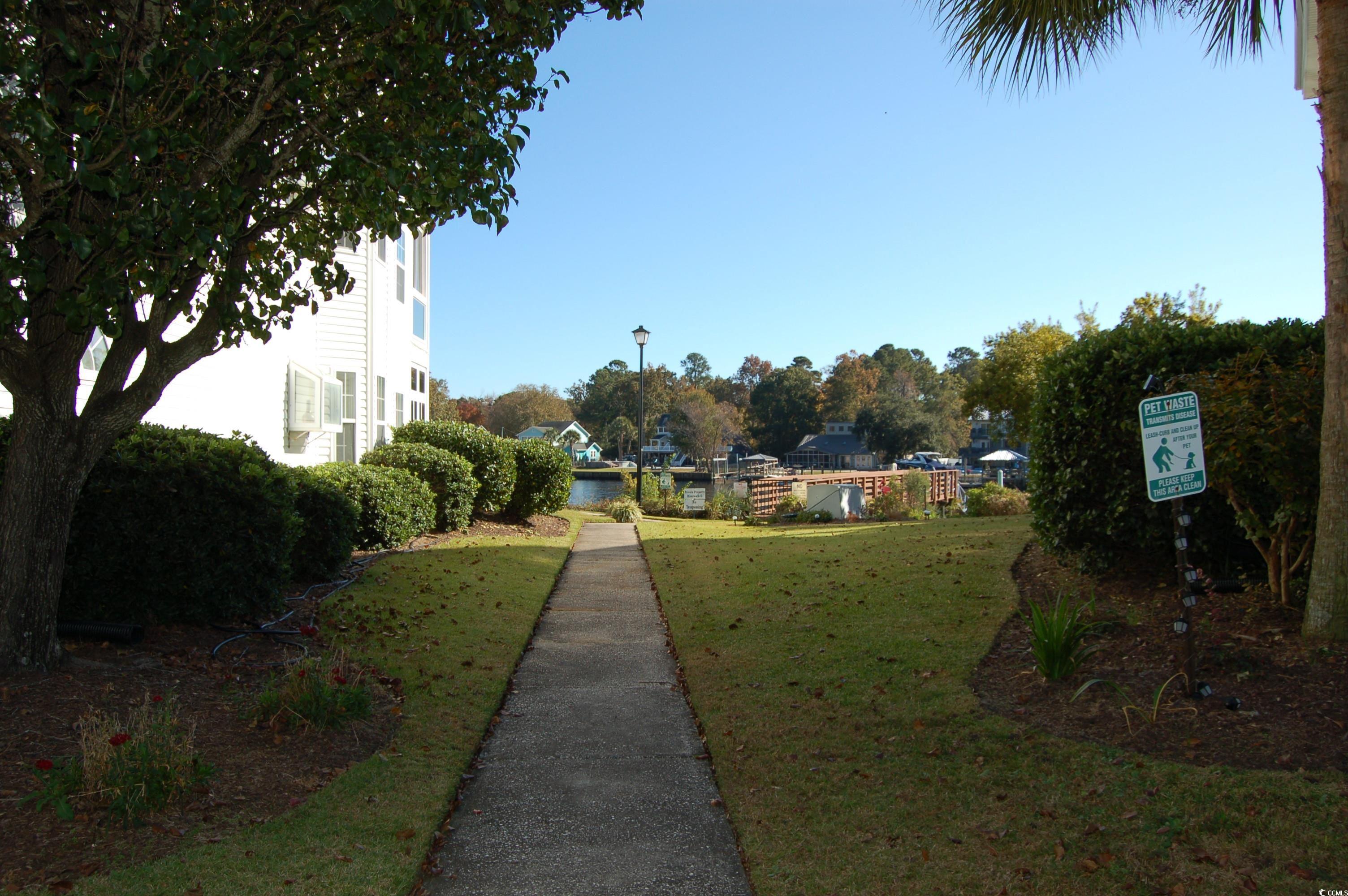 1537 Lanterns Rest Road, Unit 203 Myrtle Beach, SC 29579 - Photo 26 of 35 View of home's community featuring a lawn