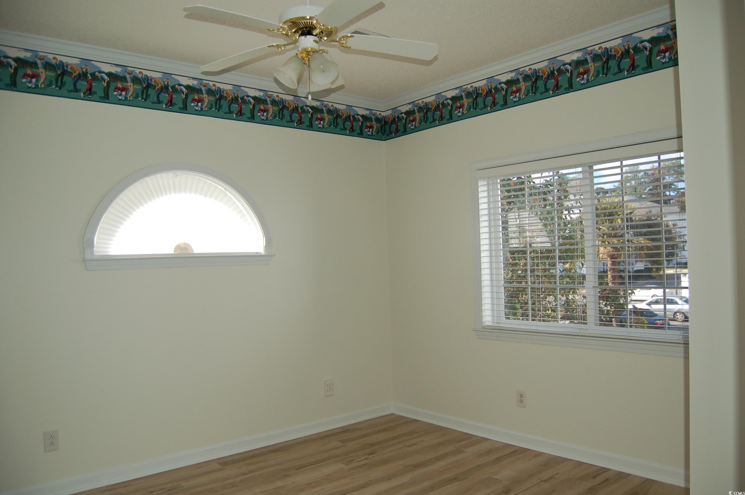 1537 Lanterns Rest Road, Unit 203 Myrtle Beach, SC 29579 - Photo 6 of 35 Spare room featuring wood finished floors, Crown molding, plenty of natural light, and ceiling fan