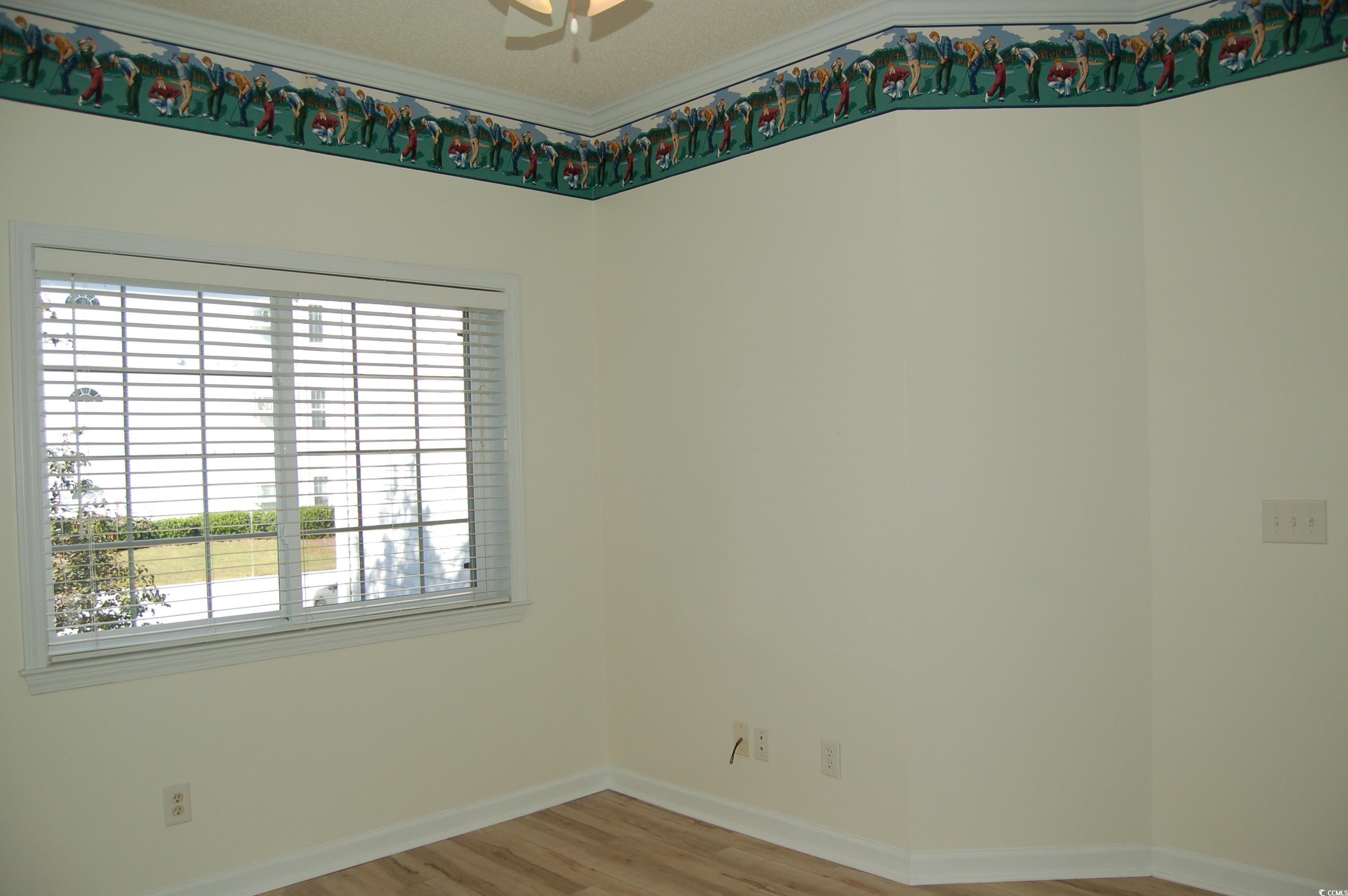1537 Lanterns Rest Road, Unit 203 Myrtle Beach, SC 29579 - Photo 7 of 35 Spare room with light wood-style floors and ornamental molding