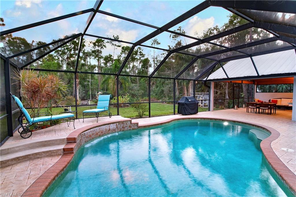 5340 Tamarind Ridge Drive Naples, FL 34119 - Photo 1 of 32 a view of swimming pool with a porch
