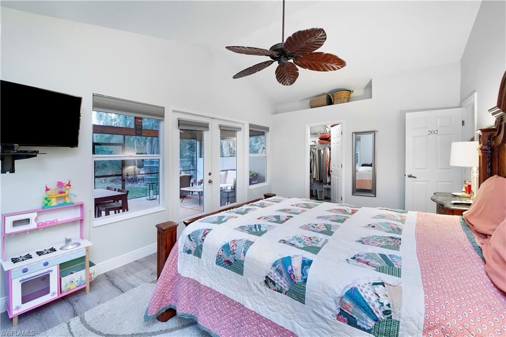 5340 Tamarind Ridge Drive Naples, FL 34119 - Photo 12 of 32 a bedroom with a bed and a flat screen tv