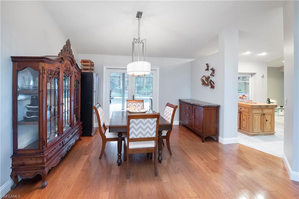 5340 Tamarind Ridge Drive Naples, FL 34119 - Photo 16 of 32 a view of a dining room with furniture window and wooden floor