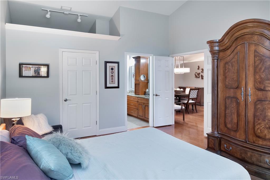 5340 Tamarind Ridge Drive Naples, FL 34119 - Photo 21 of 32 a bedroom with a bed and furniture