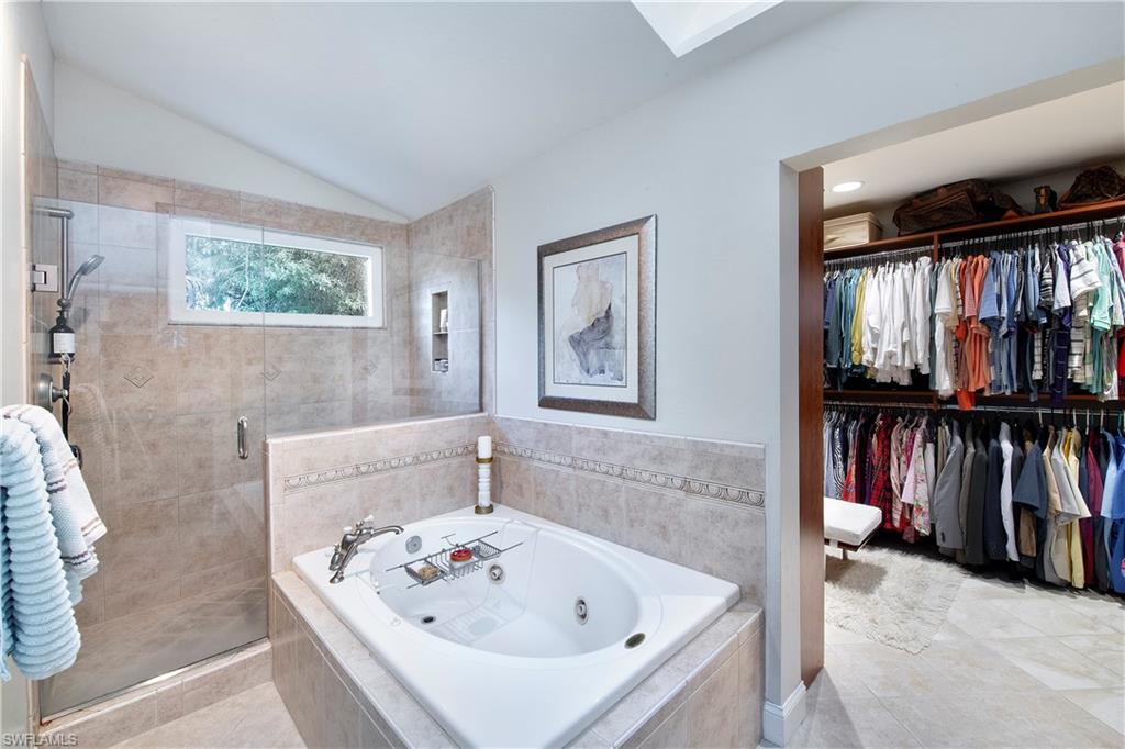 5340 Tamarind Ridge Drive Naples, FL 34119 - Photo 24 of 32 a bathroom with a bathtub and a window