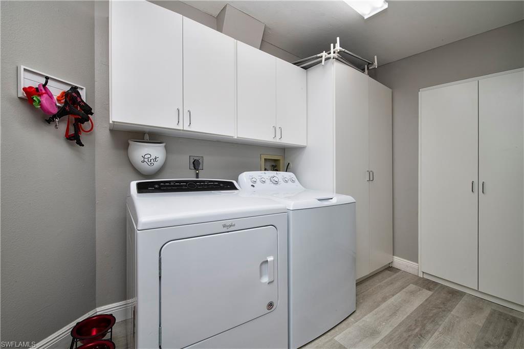 5340 Tamarind Ridge Drive Naples, FL 34119 - Photo 27 of 32 a utility room with dryer and washer
