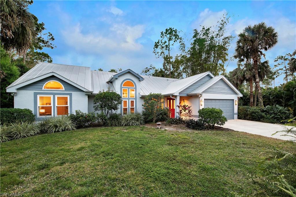 5340 Tamarind Ridge Drive Naples, FL 34119 - Photo 29 of 32 a front view of house with yard and green space