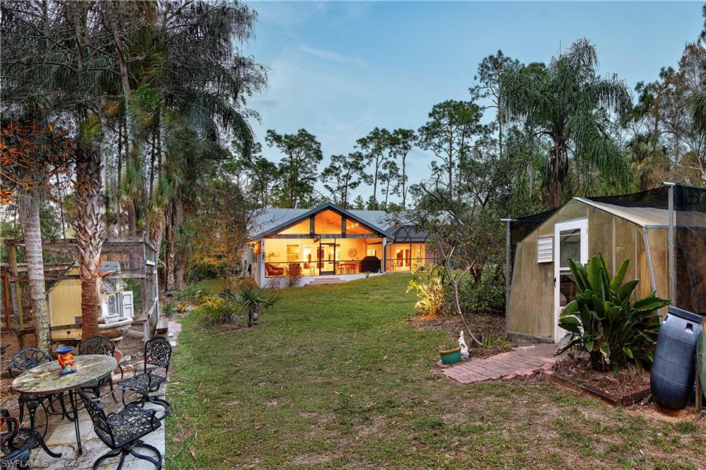 5340 Tamarind Ridge Drive Naples, FL 34119 - Photo 31 of 32 a view of a backyard with plants and a patio