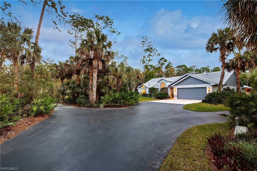 5340 Tamarind Ridge Drive Naples, FL 34119 - Photo 32 of 32 a view of a house with a yard and large trees