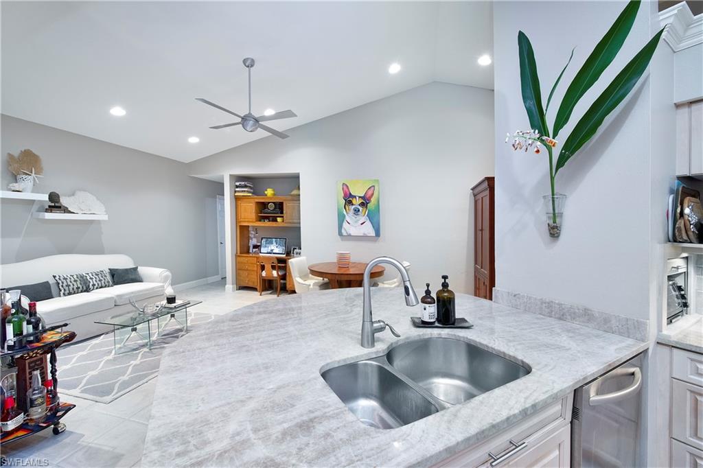 5340 Tamarind Ridge Drive Naples, FL 34119 - Photo 7 of 32 a kitchen with sink cabinets and a potted plant