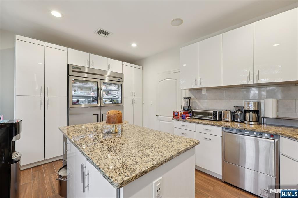 14 Henion Garden Mahwah, NJ 07430 - Photo 14 of 38 a kitchen with stainless steel appliances granite countertop a sink stove and cabinets