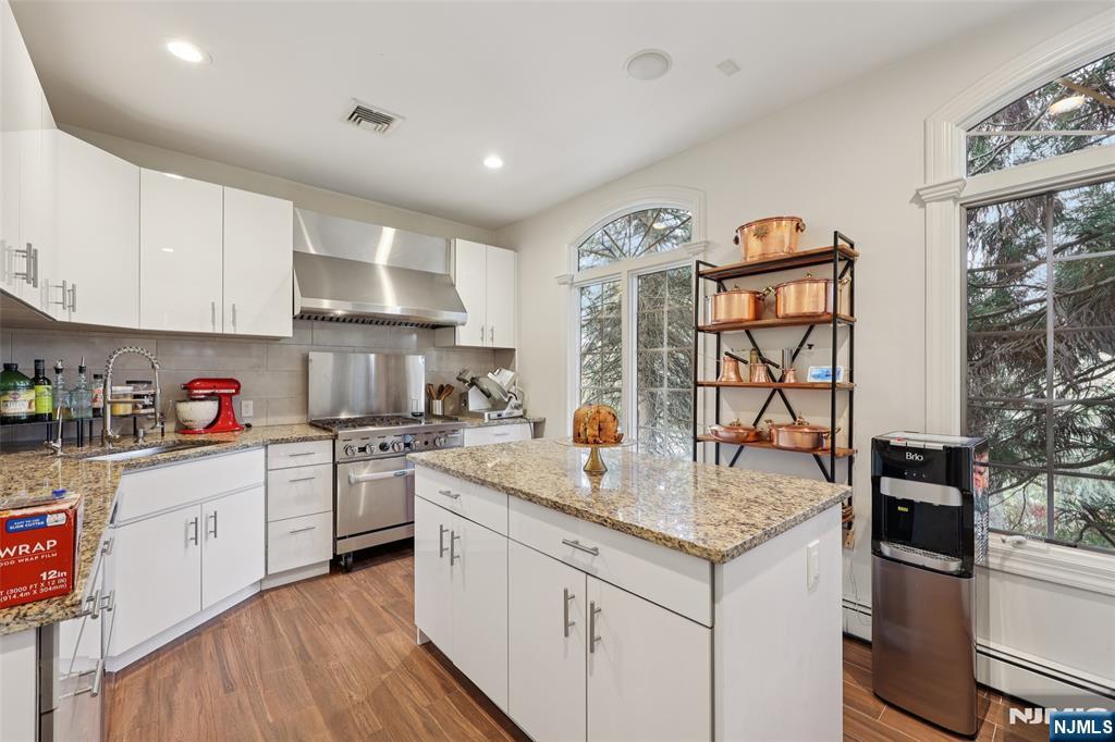 14 Henion Garden Mahwah, NJ 07430 - Photo 15 of 38 a kitchen with granite countertop a sink stove and cabinets