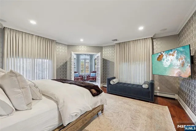 a bedroom with furniture and a flat screen tv