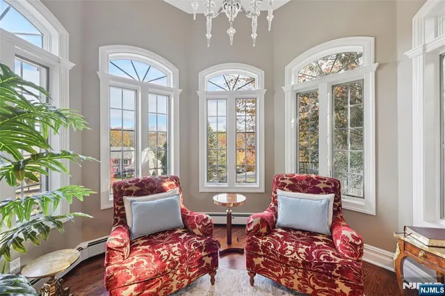 a living room with patio furniture and a large window