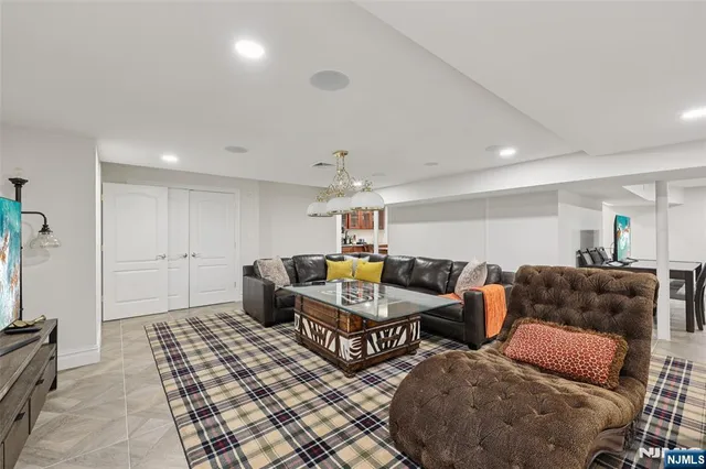 a living room with furniture and a chandelier