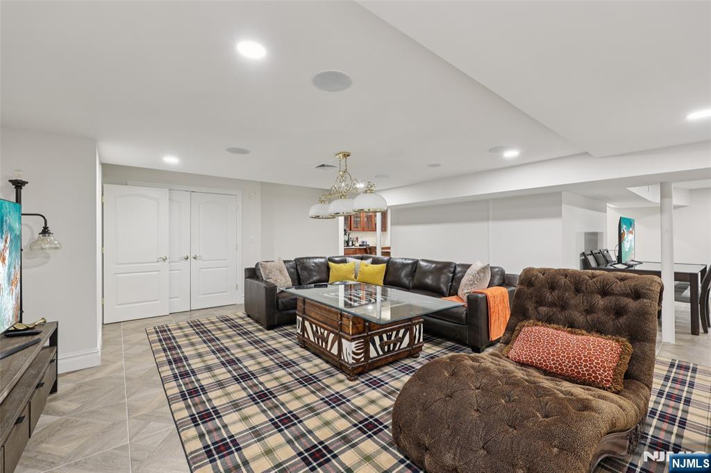 14 Henion Garden Mahwah, NJ 07430 - Photo 25 of 38 a living room with furniture and a chandelier
