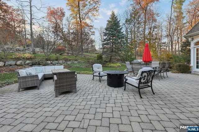 a view of a patio with dining table and chairs with a fire pit
