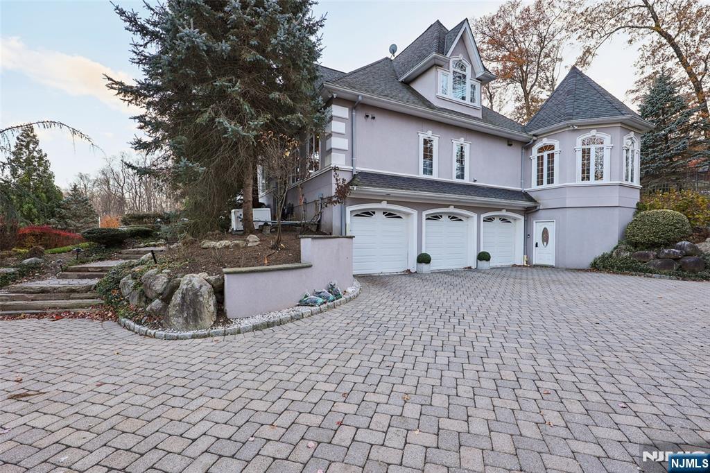 14 Henion Garden Mahwah, NJ 07430 - Photo 32 of 38 a front view of a house with a yard