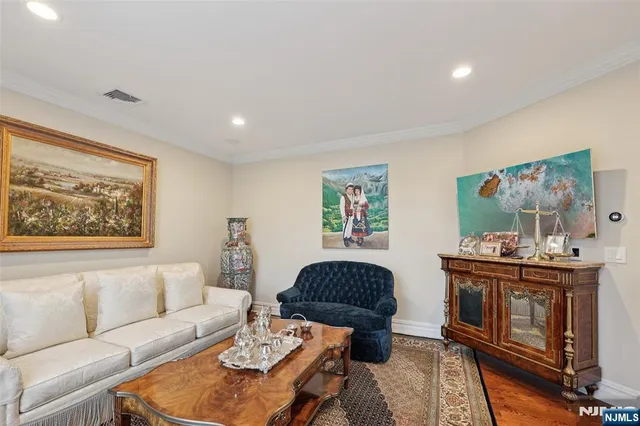 a living room with furniture and paintings on the wall