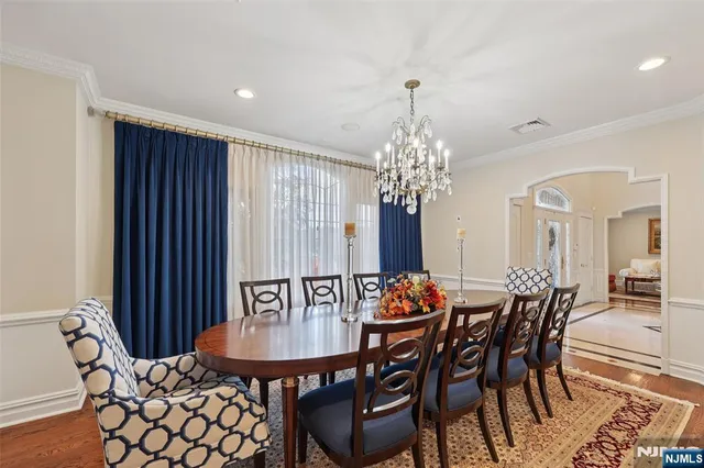 a view of a dining room with furniture and chandelier