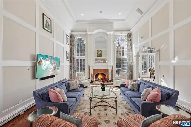 a living room with furniture a fireplace and a large window