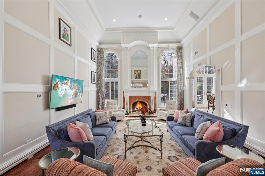 14 Henion Garden Mahwah, NJ 07430 - Photo 6 of 38 a living room with furniture a fireplace and a large window