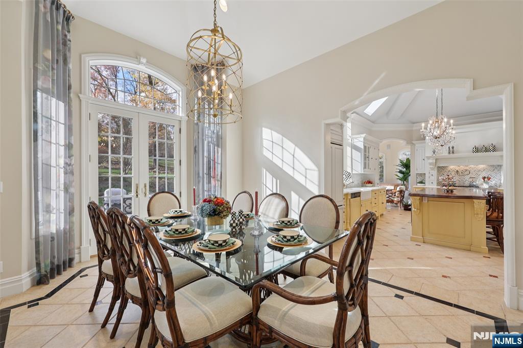 14 Henion Garden Mahwah, NJ 07430 - Photo 8 of 38 a dining room with furniture a chandelier and wooden floor