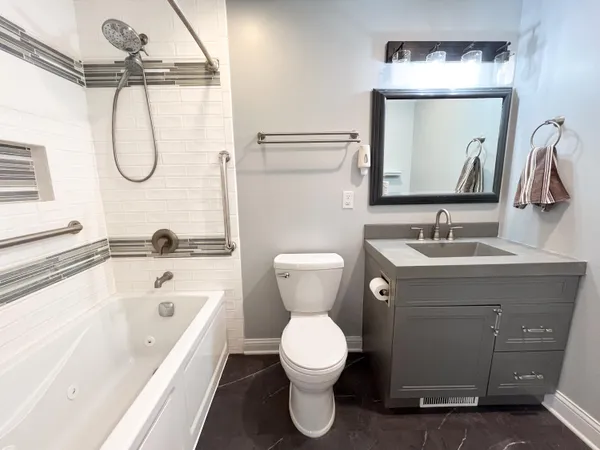 a bathroom with a toilet sink and mirror