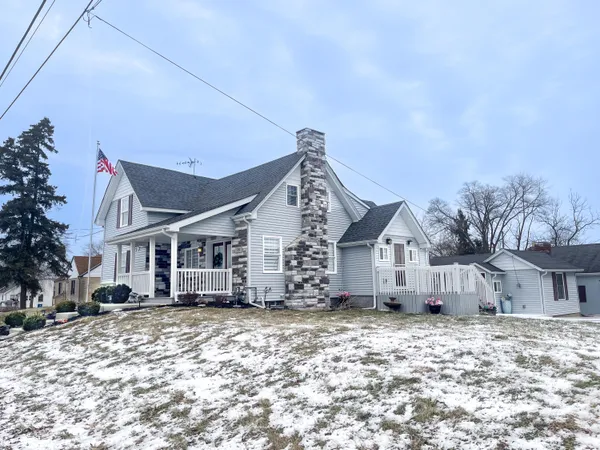 a view of a house with a yard covered in snow
