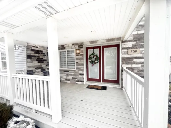 a view of a balcony with wooden floor and fence