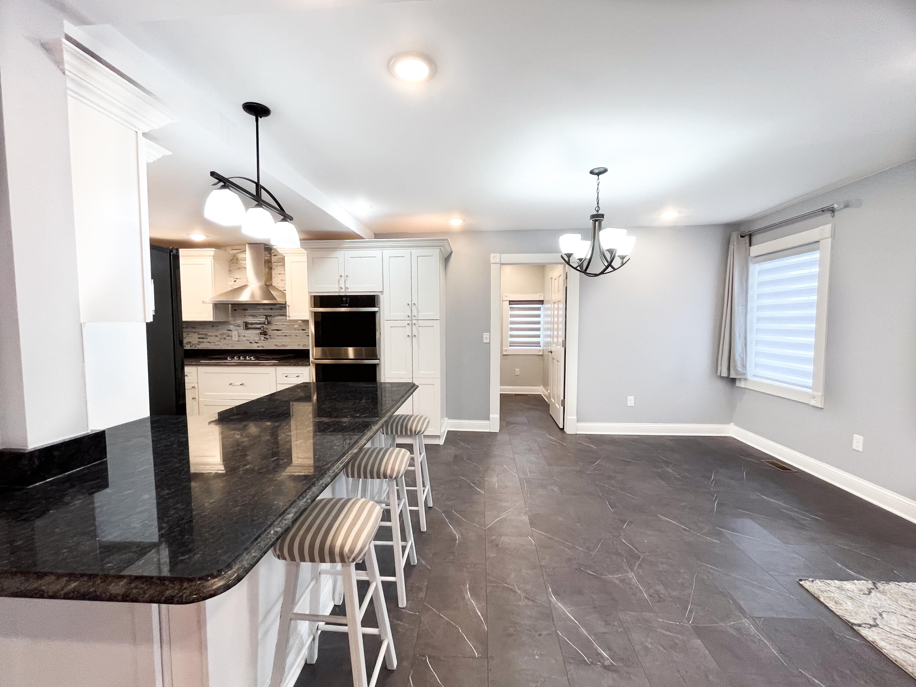 509 North Main Street Hebron, IN 46341 - Photo 9 of 27 a view of a dining room and livingroom with furniture wooden floor a chandelier